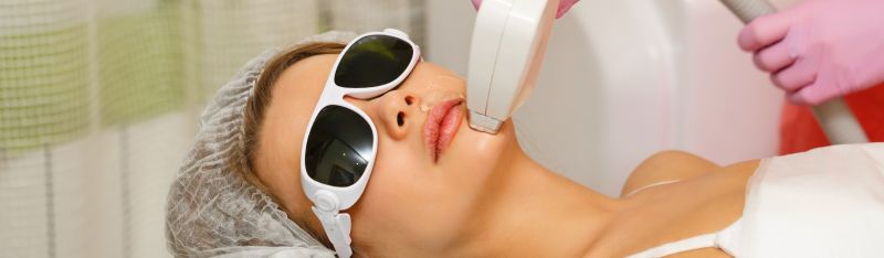 A woman smiling confidently after laser treatment at a professional skin clinic, reflecting emotional transformation and clear, radiant skin.